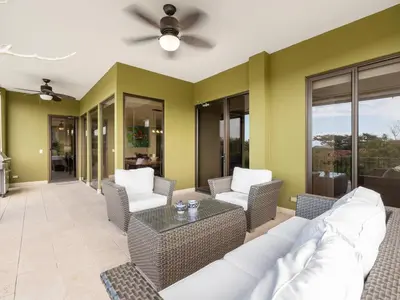 a living room with a couch and chairs and a table at Stunning Spacious Luxury Condo 5-Star Reserva Conchal - Carao in Playa Conchal