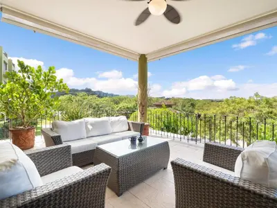a patio with a couch and chairs and a table at Stunning Spacious Luxury Condo 5-Star Reserva Conchal - Carao in Playa Conchal