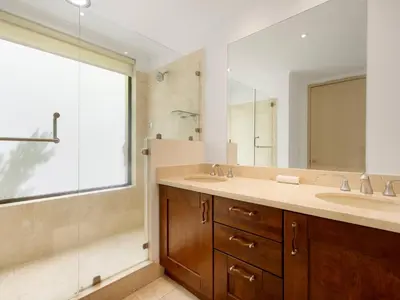 a bathroom with two sinks and a shower at Stunning Spacious Luxury Condo 5-Star Reserva Conchal - Carao in Playa Conchal