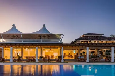 a building with a pool in front of it at Stunning Spacious Luxury Condo 5-Star Reserva Conchal - Carao in Playa Conchal