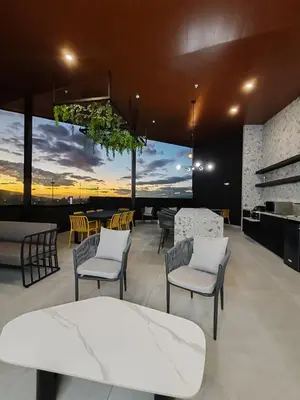 a restaurant with chairs and a table and a view of the city at Valle de Escalante in San José