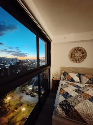a bedroom with a bed and a large window at Valle de Escalante in San José