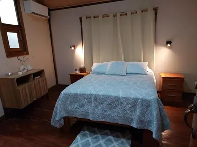 a bedroom with a bed with a blue comforter at Chilamate Jungle View in Tortuguero