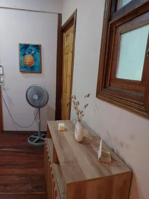 a wooden table in a room with a window at Chilamate Jungle View in Tortuguero