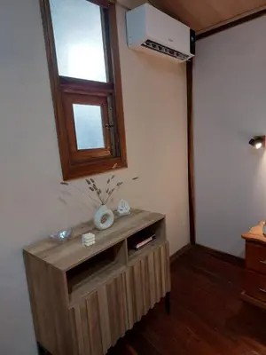 a room with a wooden cabinet with a window at Chilamate Jungle View in Tortuguero