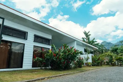 a white building with plants in front of it at Arenal View Villas in Fortuna