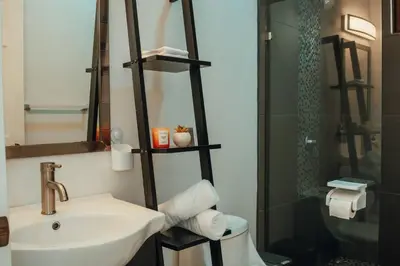 a bathroom with a sink and a toilet and a shower at Arenal View Villas in Fortuna