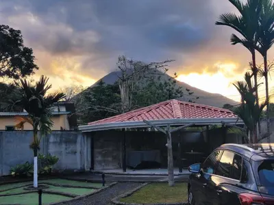 a car parked in front of a house with a gazebo at Arenal View Villas in Fortuna