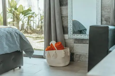 a basket filled with orange shoes in a bedroom at Arenal View Villas in Fortuna