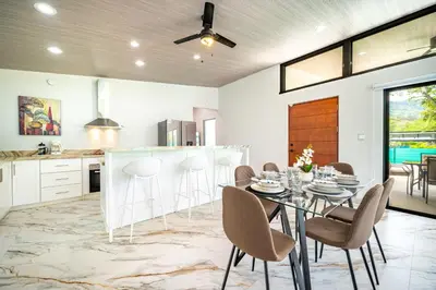 a kitchen and dining room with a table and chairs at Casa Montana Azul @ Catalina Cove in Brasilito