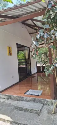 an empty house with a wooden floor and an open door at Stella's Santa Teresa in Mal País