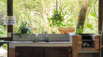 a kitchen counter with a sink in front of a window at Stella's Santa Teresa in Mal País