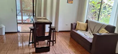 a living room with a couch and a table at Stella's Santa Teresa in Mal País