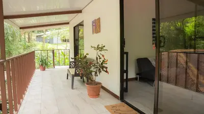a porch with a glass door and a plant at Stella's Santa Teresa in Mal País
