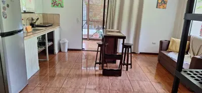 a kitchen with a counter and a table in a room at Stella's Santa Teresa in Mal País