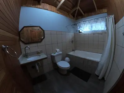 a bathroom with a toilet and a sink and a tub at Laureles Collection Uvita - Cabinas Los Laureles in Uvita