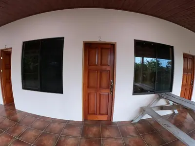 a room with two windows and a door at Laureles Collection Uvita - Cabinas Los Laureles in Uvita
