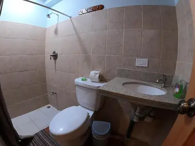 a bathroom with a toilet and a sink at Laureles Collection Uvita - Cabinas Los Laureles in Uvita