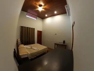a room with a bed and a ceiling fan at Laureles Collection Uvita - Cabinas Los Laureles in Uvita