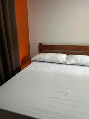 a bed with two pillows on it in a room at Casa La Vega in Florencia