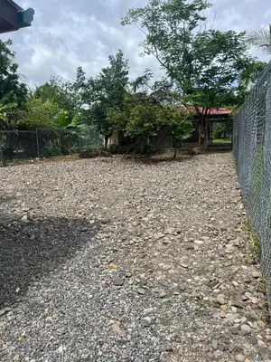 a fence in front of a yard with trees at Casa La Vega in Florencia