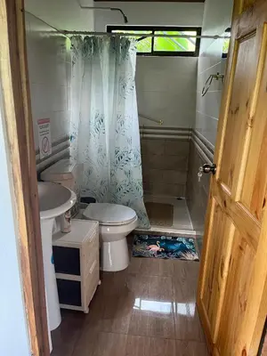 a bathroom with a toilet and a sink and a shower at Casa La Vega in Florencia