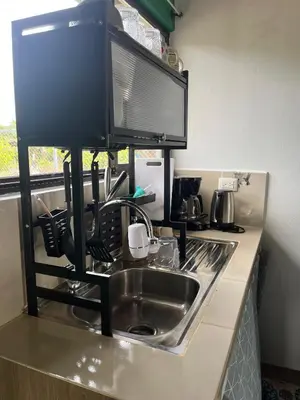a kitchen counter with a sink and a microwave at Casa La Vega in Florencia