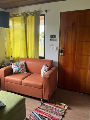 a living room with a couch and a door at Casa La Vega in Florencia