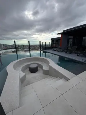 a swimming pool with a bench on a building at Excellent location, beautiful apartment in San José