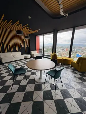 a lobby with a table and chairs and a view at Excellent location, beautiful apartment in San José