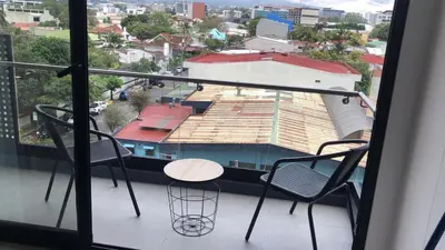 a view of a balcony with two chairs and a table at Excellent location, beautiful apartment in San José