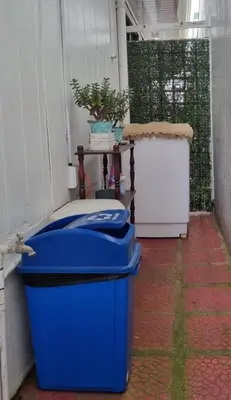a blue trash can sitting on the side of a building at Apartamento Adriana in Cartago