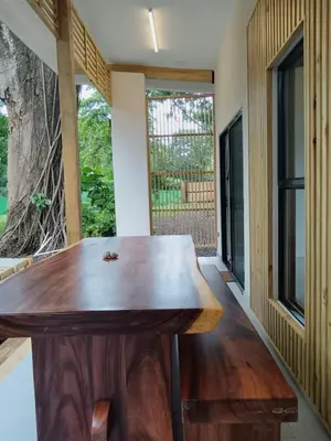 a wooden table in a room with a window at Santa Teresa Manzanillo Walk to Beach, New Home, Center of Tranquil Town in Boca de Ario