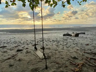 a swing on a beach with the ocean at Santa Teresa Manzanillo Walk to Beach, New Home, Center of Tranquil Town in Boca de Ario