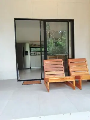 two wooden benches sitting in front of a building at Santa Teresa Manzanillo Walk to Beach, New Home, Center of Tranquil Town in Boca de Ario