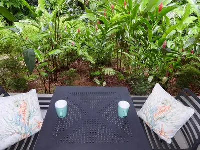 a black table with two cups on top at Colibri Jungle Casita in Dominical
