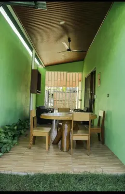 a dining room with a wooden table and chairs at Casa Jicaro in Nosara