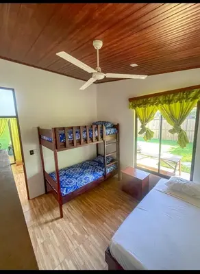 a bedroom with two bunk beds and a ceiling fan at Casa Jicaro in Nosara