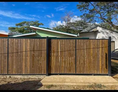 a wooden gate in front of a house at Casa Jicaro in Nosara