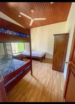 a room with two bunk beds and a ceiling at Casa Jicaro in Nosara
