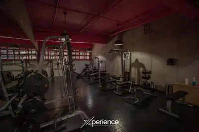 a gym with rows of exercise equipment in a room at Lux at 15, Pool, Gym and Stylish City Stay in Hatillo