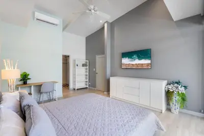 a bedroom with a white bed and a white dresser at Sprawling Modern Property with a Tranquil Outdoor Living Space swimming pool and a private Casita in Playa Flamingo