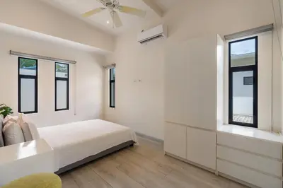 a white bedroom with a bed and windows at Sprawling Modern Property with a Tranquil Outdoor Living Space swimming pool and a private Casita in Playa Flamingo