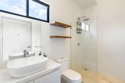 a white bathroom with a sink and a toilet at Sprawling Modern Property with a Tranquil Outdoor Living Space swimming pool and a private Casita in Playa Flamingo