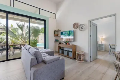 a living room with a couch and a table at Sprawling Modern Property with a Tranquil Outdoor Living Space swimming pool and a private Casita in Playa Flamingo
