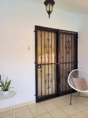 an iron gate in a room with a table and chairs at Garza Real in Coco