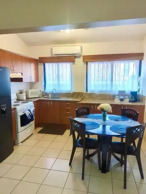 a kitchen with a table and chairs and a kitchen with a stove at Garza Real in Coco