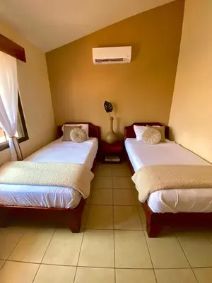 a room with two beds in a room at Garza Real in Coco