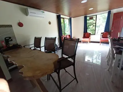 a dining room with a wooden table and chairs at Quinta Rincon Silvestre cerca de Volcán in Jabillos