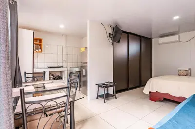 a small room with a bed and a kitchen at Castro's Apartment in Fortuna